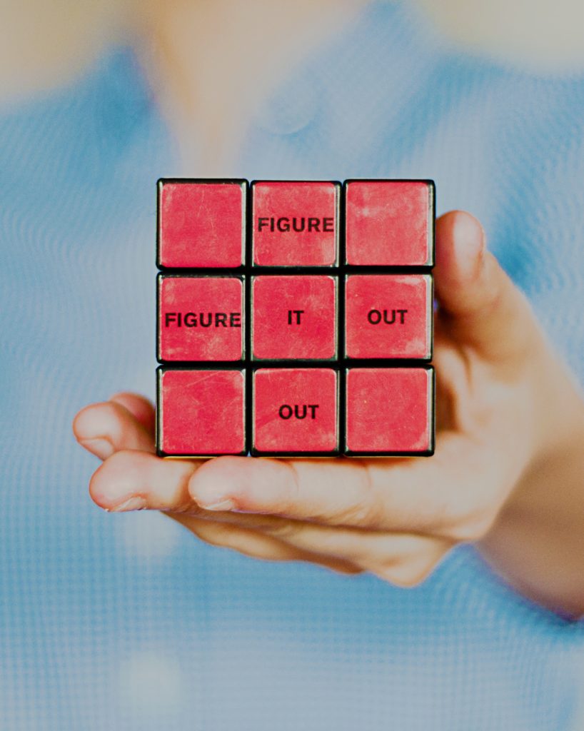 a Rubik's cube with the words "figure it out" printed on the face 