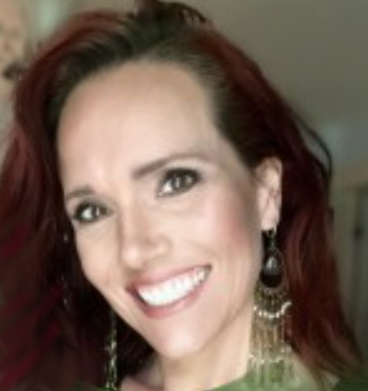 Amy has long dark hair and is smiling into the camera.