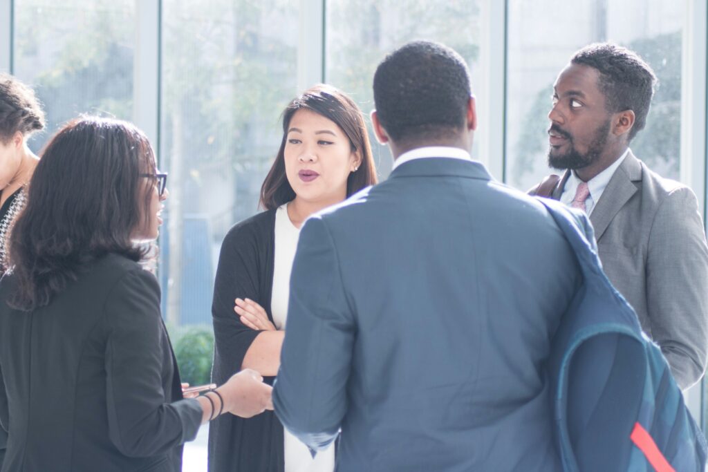 A group of employees are having a discussion outside the conference room after their last meeting, trying to figure out what the new priorities really are. Photo by The Jopwell Collection on Unsplash